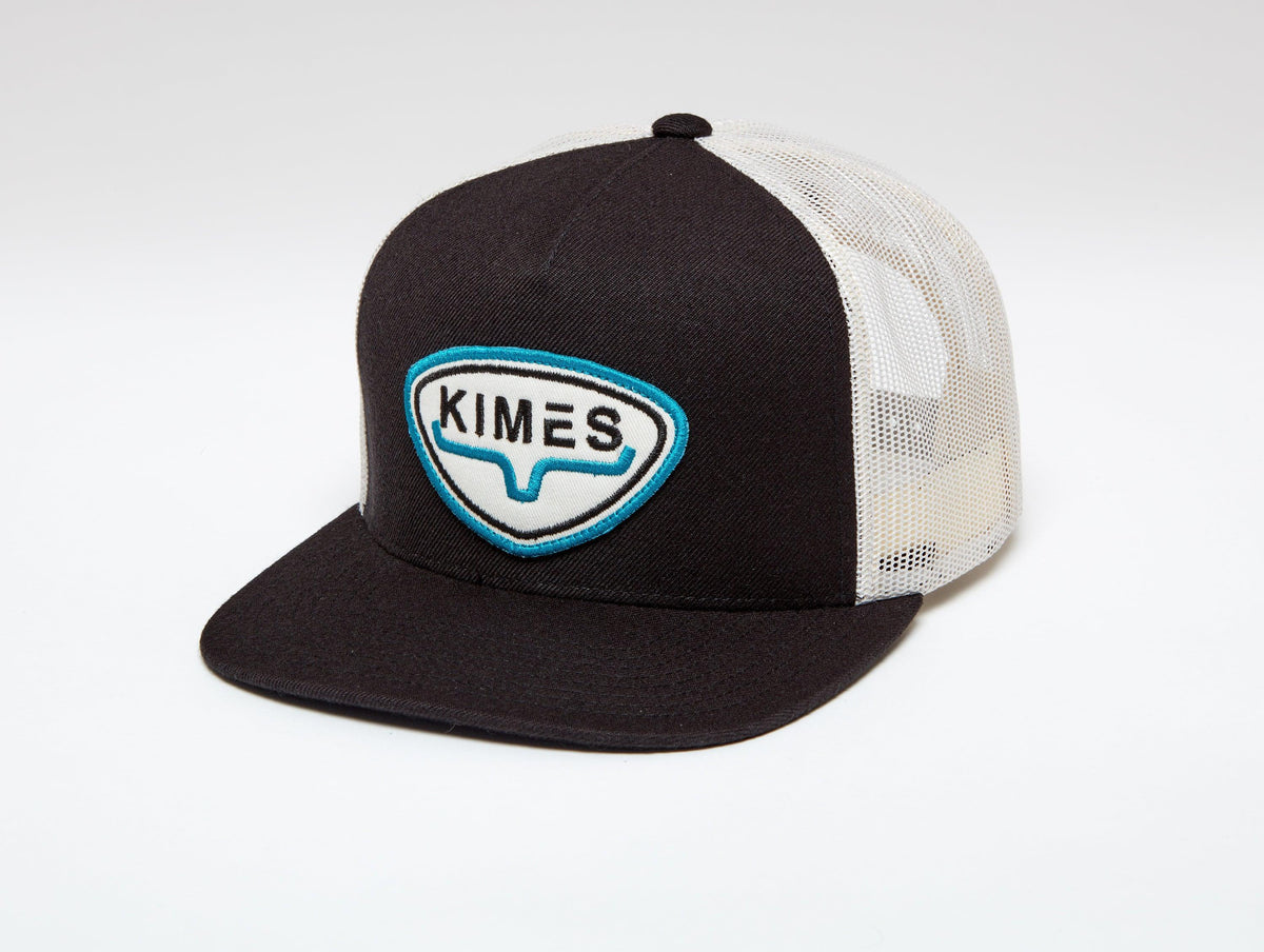 Kimes Ranch Conway Trucker Hat in Black with a front embroidered logo patch and white mesh back panels