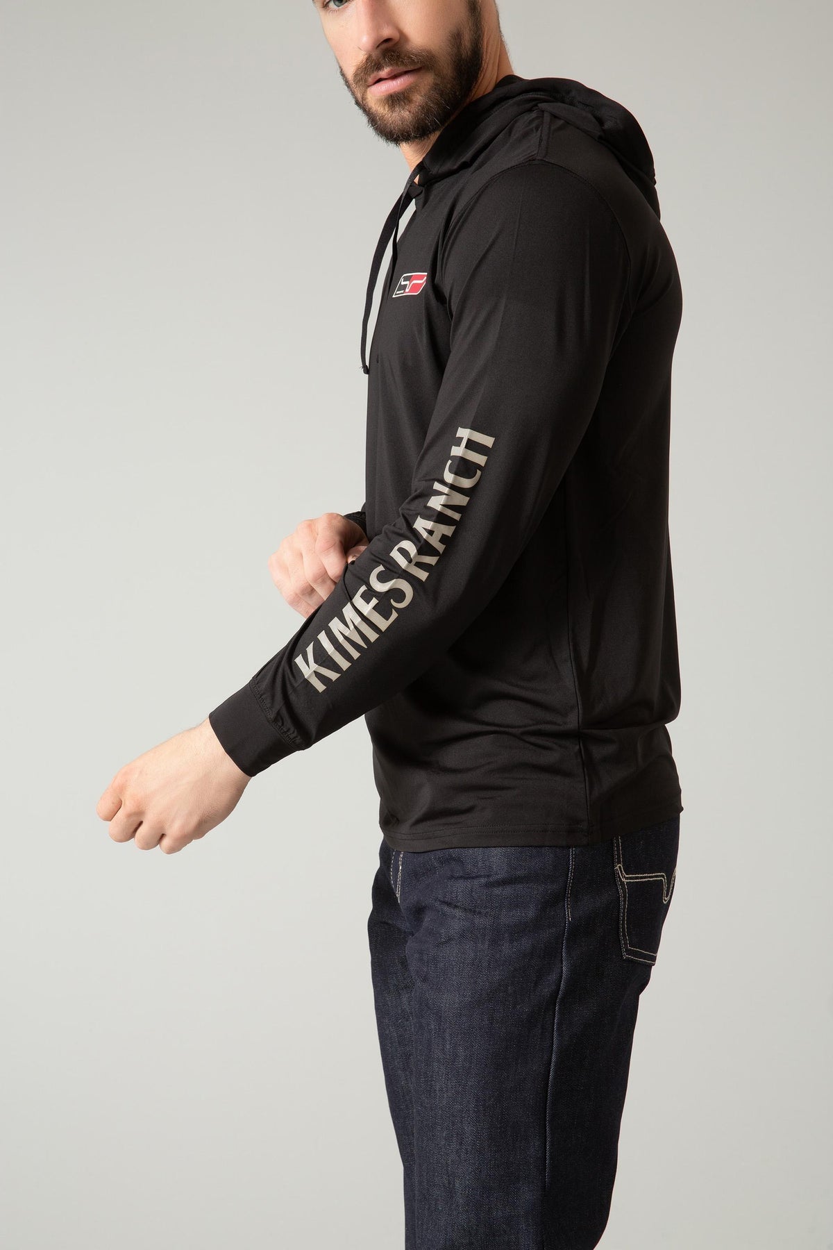 Kimes Ranch Ninja Hood Tech Tee Shirt in Black, side view, with Kimes Ranch logo on chest and sleeve