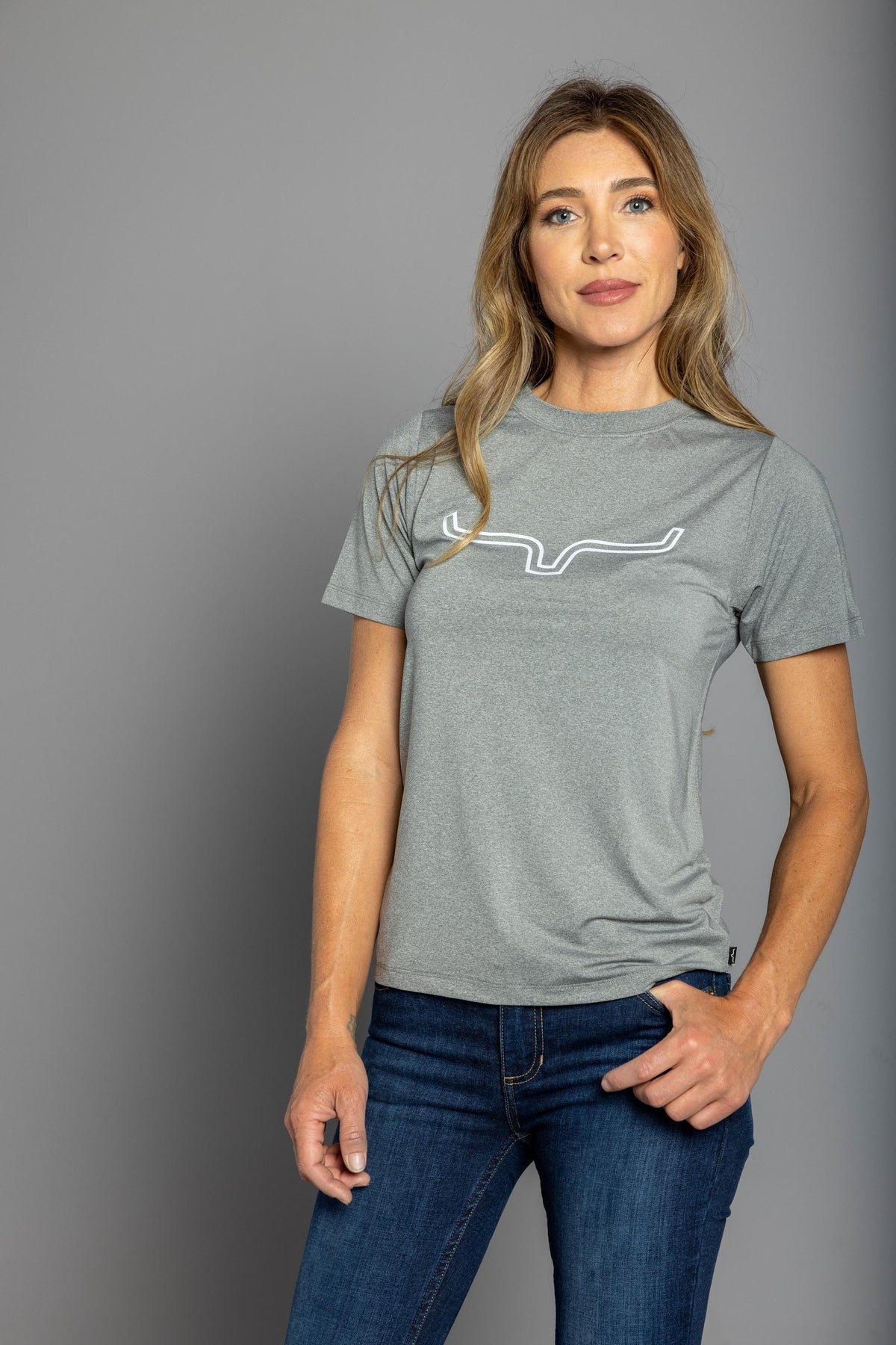 Kimes Ranch Ladies Outlier Tech Tee Shirt in Grey Heather with a white outline steer logo on the chest