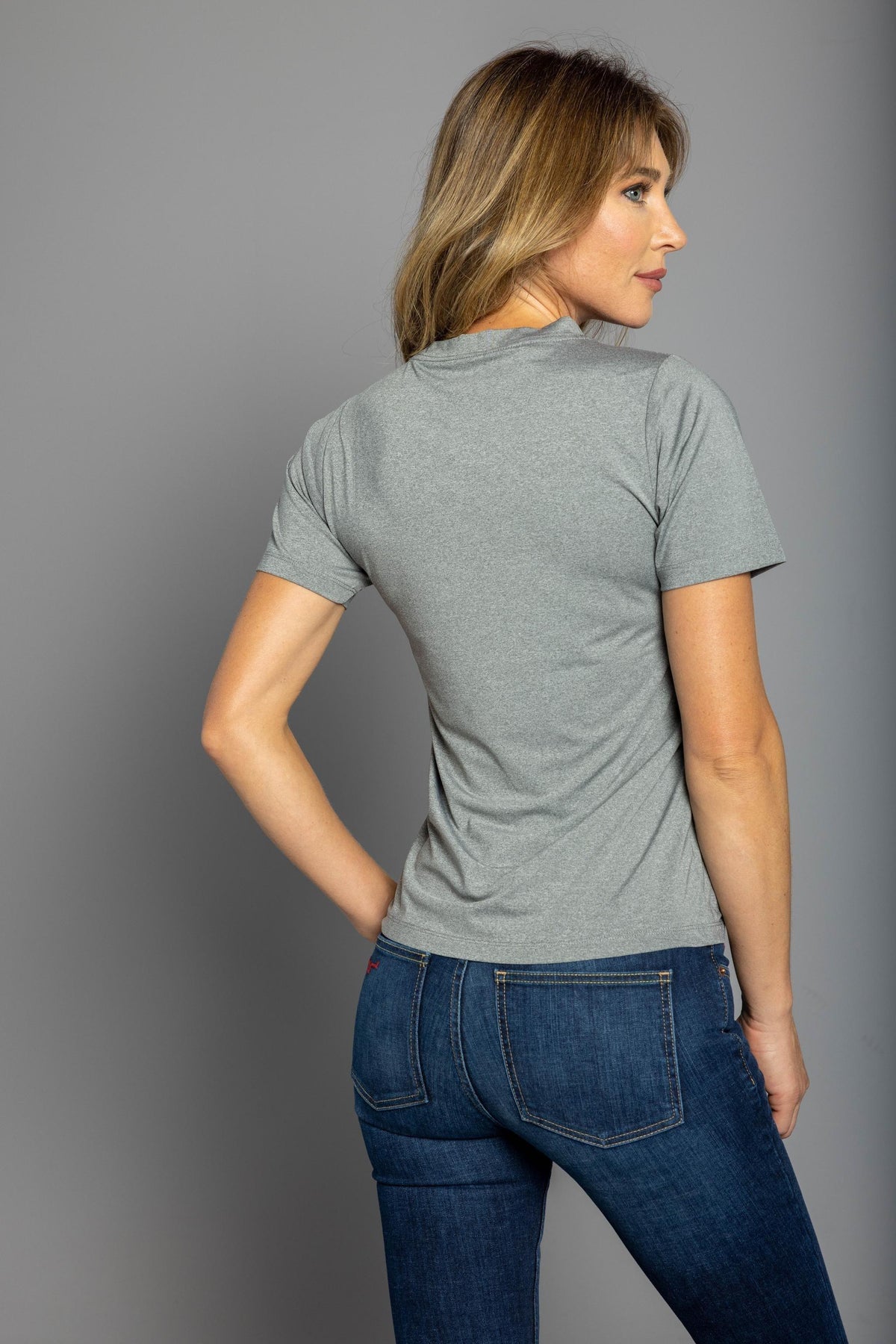 Kimes Ranch Ladies Outlier Tech Tee Shirt in Grey Heather, back view, with short sleeves and a crew neck