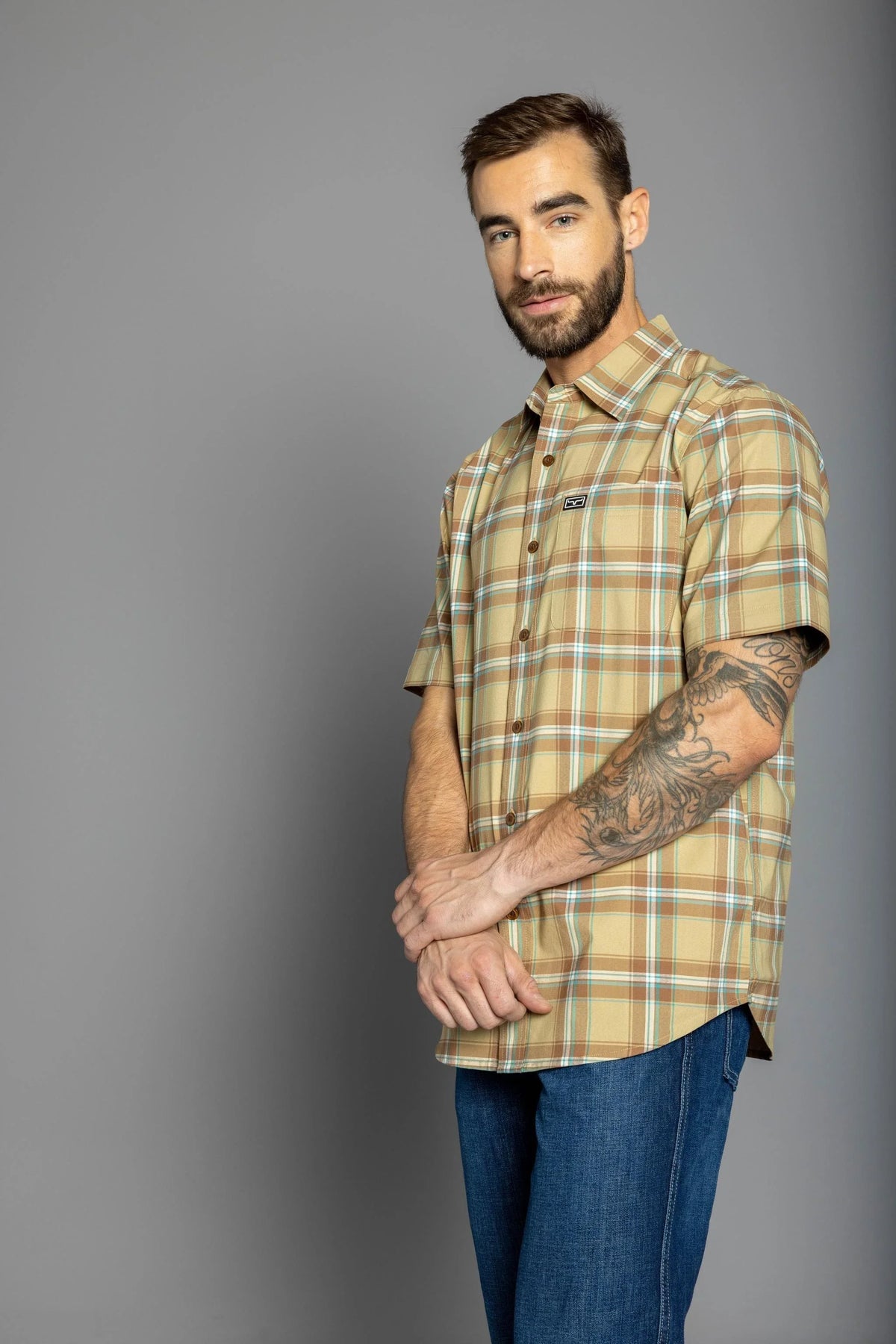 Kimes Ranch 4 Stroke Plaid Dress Shirt in Work Wear Brown, side view, with short sleeves and a chest pocket