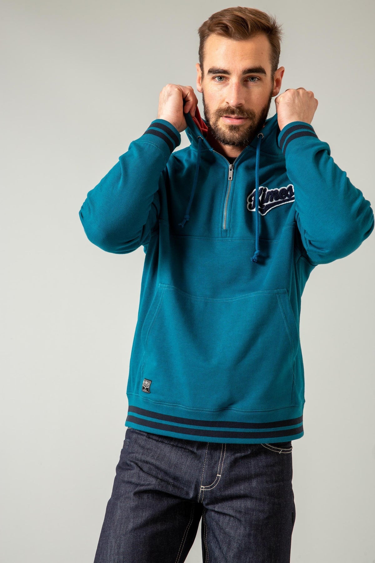 Kimes Ranch Team One Hoodie in Dark Blue with a half-zip front, a front kangaroo pocket, and a Kimes Ranch logo on the chest