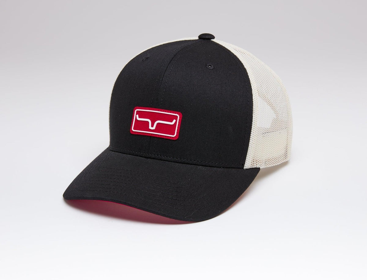 Kimes Ranch Team Pro Trucker Hat in Black, side view, with red logo patch and cream mesh back