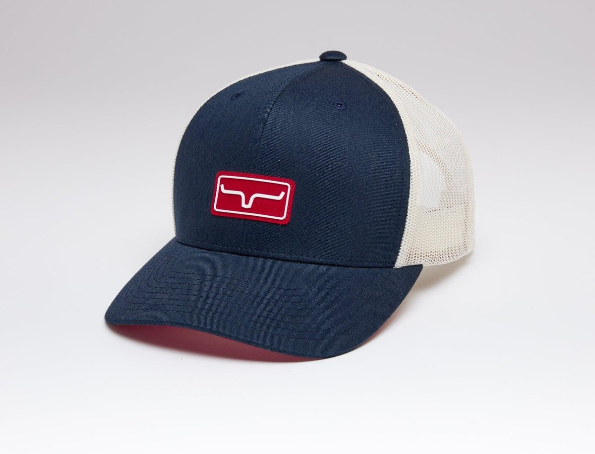 Kimes Ranch Team Pro Trucker Hat in Navy, side view, with red logo patch and cream mesh back