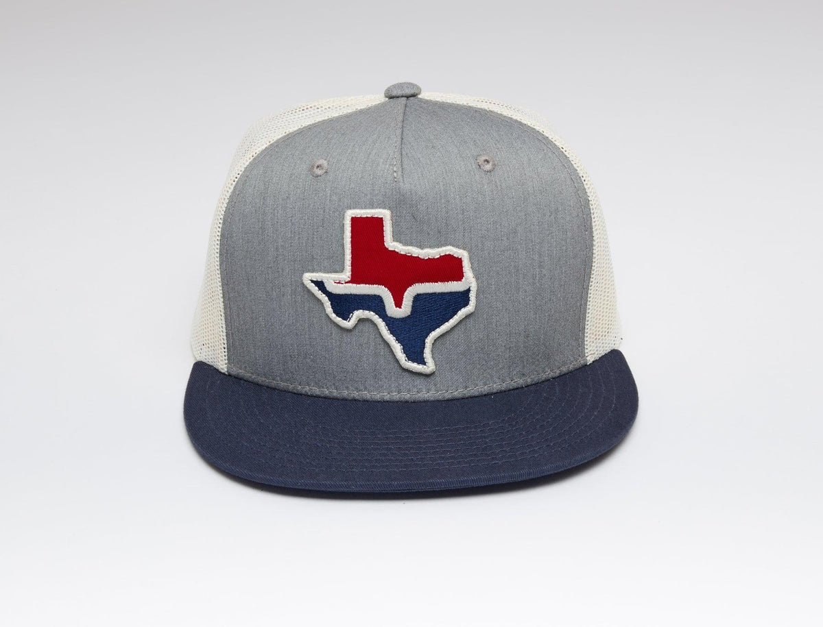 Kimes Ranch Texas Trucker Hat with a grey front panel, navy brim, and a Texas state outline graphic in red and blue